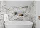 Relaxing bathroom with a freestanding tub and marble accents at 716 14Th Ne Ave, St Petersburg, FL 33701