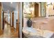 Elegant bathroom with pink tile, marble vanity, and gold fixtures at 716 14Th Ne Ave, St Petersburg, FL 33701