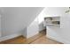 Bright white attic closet with wood floors and shelving for storage at 716 14Th Ne Ave, St Petersburg, FL 33701