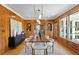 Elegant dining room with wood walls, a long table, and statement lighting at 716 14Th Ne Ave, St Petersburg, FL 33701