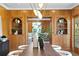 Open dining room with built-in shelving and view into living area at 716 14Th Ne Ave, St Petersburg, FL 33701
