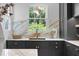 Sleek kitchen with dark cabinetry, marble backsplash, and farmhouse sink at 716 14Th Ne Ave, St Petersburg, FL 33701