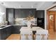 Modern kitchen with dark cabinetry, marble countertops, and island at 716 14Th Ne Ave, St Petersburg, FL 33701