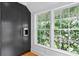 Modern kitchen features dark cabinetry, built-in beverage center, and large windows at 716 14Th Ne Ave, St Petersburg, FL 33701