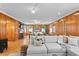 Open living area with hardwood floors, sectional sofa, and wood paneled walls at 716 14Th Ne Ave, St Petersburg, FL 33701