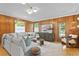 Living room with wood paneled walls, sectional sofa and hardwood floors at 716 14Th Ne Ave, St Petersburg, FL 33701