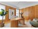 Bright home office featuring wood walls and stylish mid-century modern furniture at 716 14Th Ne Ave, St Petersburg, FL 33701