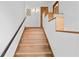 Modern staircase with light wood and a simple handrail at 716 14Th Ne Ave, St Petersburg, FL 33701