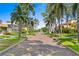 Brick-paved street lined with lush landscaping and palm trees at 716 14Th Ne Ave, St Petersburg, FL 33701