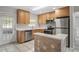 Modern kitchen with stainless steel appliances and wood cabinets at 861 88Th N Ave, St Petersburg, FL 33702