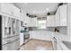 Spacious kitchen with stainless steel appliances and white cabinets at 3134 Francoa Dr, Odessa, FL 33556