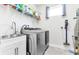 Bright laundry room with washer, dryer, and utility sink at 3134 Francoa Dr, Odessa, FL 33556