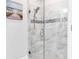 Large walk-in shower with marble tile and built-in seat at 3134 Francoa Dr, Odessa, FL 33556