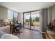 Bedroom with private balcony access, desk and chair, and view of the golf course at 5700 Escondida S Blvd # 306, St Petersburg, FL 33715