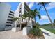 Building exterior showcasing entrance, landscaping, and a waterfront view at 5700 Escondida S Blvd # 306, St Petersburg, FL 33715