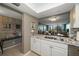 Modern kitchen with granite countertops, white cabinets, and a view into the living room at 5700 Escondida S Blvd # 306, St Petersburg, FL 33715
