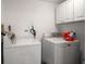 Laundry room with washer, dryer, and overhead cabinets at 5700 Escondida S Blvd # 306, St Petersburg, FL 33715