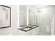 Elegant bathroom with double sinks, large mirror, and walk-in shower at 411 E Shore Drive # Ph10, Clearwater Beach, FL 33767