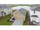 Tan one-story house with a two-car garage, viewed from above at 5552 Logan Cave Ave, Wimauma, FL 33598
