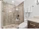 Modern bathroom with a glass shower enclosure, built-in shower seat, and updated toilet at 1910 E Palm Ave # 11303, Tampa, FL 33605