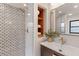 An elegant bathroom features a modern vanity, patterned glass shower, and recessed storage shelves at 5518 21St S Ave, Gulfport, FL 33707