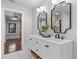 Bathroom featuring a white double vanity with black fixtures and decoratively framed mirrors at 5518 21St S Ave, Gulfport, FL 33707