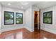 Spacious bedroom showcasing hardwood floors, a modern light fixture, a closet, and natural light at 5518 21St S Ave, Gulfport, FL 33707