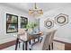 Well-lit dining room featuring wood table and four upholstered chairs on top of rug at 5518 21St S Ave, Gulfport, FL 33707