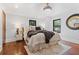 A bright main bedroom features a decorative chandelier, rug, and a plush blanket on the bed at 5518 21St S Ave, Gulfport, FL 33707