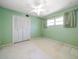 Light green bedroom with double closet and window at 3934 Venetian Way, Tampa, FL 33634