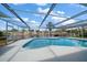 Relaxing kidney-shaped pool with screened enclosure at 3934 Venetian Way, Tampa, FL 33634