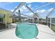 Inviting kidney-shaped pool with screened enclosure at 3934 Venetian Way, Tampa, FL 33634