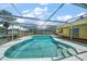 Kidney shaped pool with a screened enclosure at 3934 Venetian Way, Tampa, FL 33634