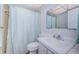 Clean bathroom with a shower curtain, sink, vanity and a mirrored wall cabinet at 1235 S Highland Ave # 2-204, Clearwater, FL 33756