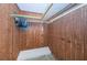 Walk-in closet featuring wood paneling and rod with hanging clothes at 1235 S Highland Ave # 2-204, Clearwater, FL 33756