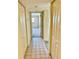 Bright hallway with tile floors and access to rooms at 7050 Sunset S Dr # 203, South Pasadena, FL 33707