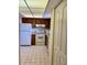 Efficient kitchen with white appliances and wood cabinets at 7050 Sunset S Dr # 203, South Pasadena, FL 33707