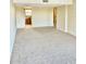 Spacious living room with neutral carpeting and open floor plan at 7050 Sunset S Dr # 203, South Pasadena, FL 33707