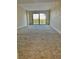 Bright living room with sliding doors to balcony and carpet at 7050 Sunset S Dr # 203, South Pasadena, FL 33707