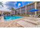 Community pool with lounge chairs and patio area at 465 Pinellas Bayway S # 307, Tierra Verde, FL 33715