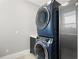 Modern laundry room with stacked washer and dryer at 191 Punta Vista Dr, St Pete Beach, FL 33706