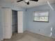 Light blue bedroom with built-in shelving and carpet at 119 Stafford Dr, Palm Harbor, FL 34684