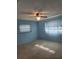 Light blue bedroom with carpet and window coverings at 119 Stafford Dr, Palm Harbor, FL 34684