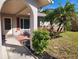 Inviting front entrance with a red brick walkway and lush landscaping at 119 Stafford Dr, Palm Harbor, FL 34684