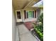 Inviting house entrance with red shutters and a walkway at 119 Stafford Dr, Palm Harbor, FL 34684