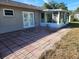 Large patio with brick pavers adjacent to house at 119 Stafford Dr, Palm Harbor, FL 34684