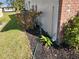 Home's exterior showcasing landscaping and utilities at 119 Stafford Dr, Palm Harbor, FL 34684