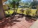 Landscaped side yard with brick pavers and tropical plants at 119 Stafford Dr, Palm Harbor, FL 34684