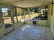Bright sunroom with tiled floor and backyard view at 119 Stafford Dr, Palm Harbor, FL 34684