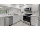 Well-lit kitchen featuring stainless steel appliances, white cabinets, and white countertops at 960 Starkey Rd # 5203, Largo, FL 33771